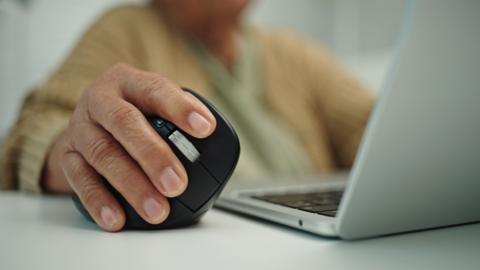 Senior woman using ergonomics mouse. - stock photo