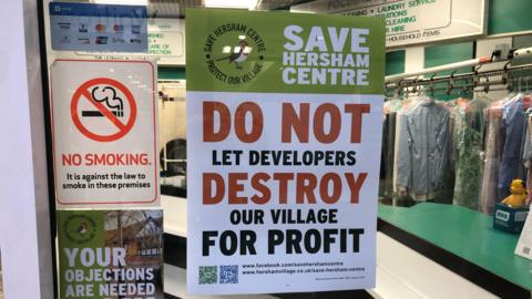 Campaign poster in window of dry cleaners in Hersham Green Shopping Centre