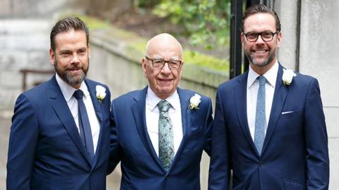 Rupert Murdoch stands with sons Lachlan Murdoch, left, and James Murdoch, right, in 2016