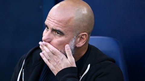 Manchester City boss Pep Guardiola reacts on the bench