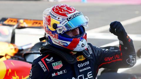 Max Verstappen clenches his left fist in celebration after climbing out of his Red Bull, having taken pole position for the Italian Grand Prix