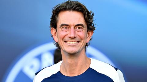 Thomas Frank smiles during a Tottenham pre-season match