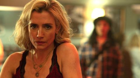 Fia Lucey sits at a bar while another woman stands behind her