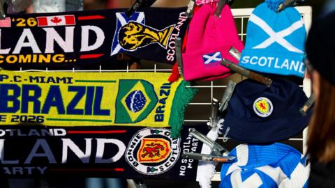A selection of colourful football scarves celebrating Scotland's appearance at the men's World Cup this summer on sale at a stand before a match.