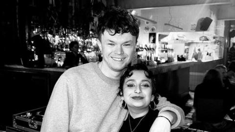 Black and white image of the couple smiling 