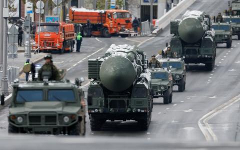 File photo: Russian military vehicles, including Yars intercontinental ballistic missile system units, drive along a road before a military parade on Victory Day