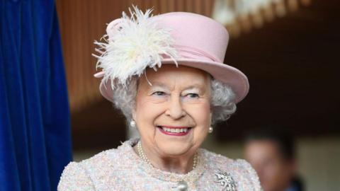  Queen Elizabeth II is seen in a pink hat smiling during an appearance at the Chichester Theatre 