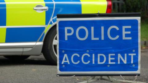 Police accident sign in front of a parked police car 