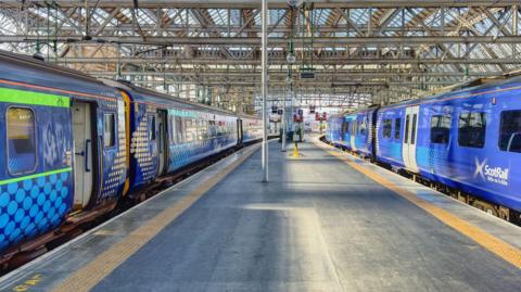 Glasgow Central train station With trains at the platform.
