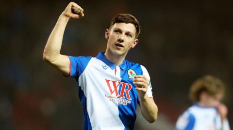 Blackburn forward Harry Leonard raises a fist to salute fans