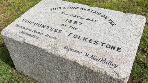 The Victoria Pleasure Pier Foundation Stone on the grass on Folkestone seafront