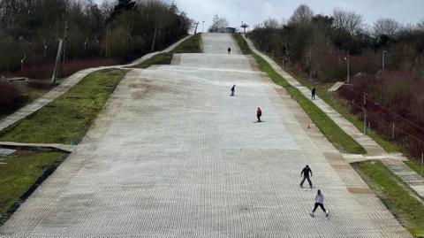 Five skiers on the dry slope at Chatham Snowsports Centre