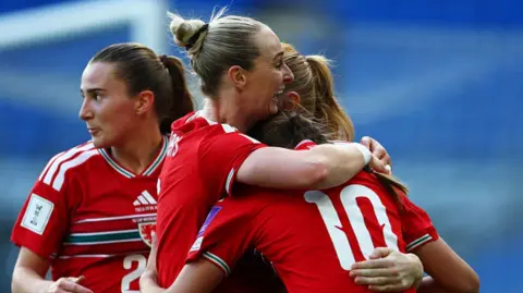 Wales' Rhiannon Roberts (centre) celebrates with Mared Griffiths (right)