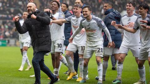 Luke Williams and his players celebrate derby victory last March