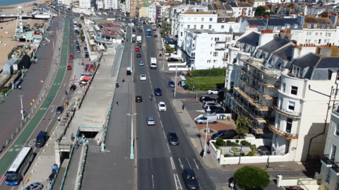 An aerial view of a busy road by a seafront.