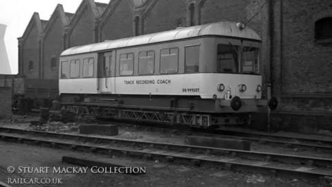 An archive image of a track recording coach parked on the rail tracks. There is a watermark for Stuart Mackay Collection and a railcar's website.
© Stuart Mackay Collection