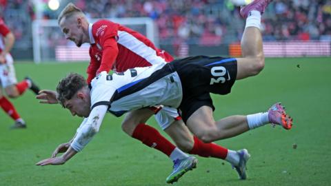 Birmingham City's Lewis Koumas goes down under a challenge from Bristol City defender Mark Sykes.