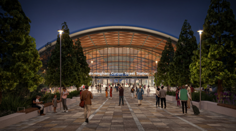 An artists impression of the new Curzon street station, showing people outside a huge arch entrance with "Birmingham Curzon Street Station" in bold white signage.