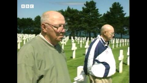 Joe and Tom Niland walk through a war graveyard