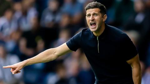 John Mousinho shouting on the sidelines