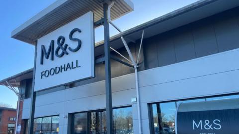 The outside of a retail unit with a large sign that reads: "M&S Foodhall." 