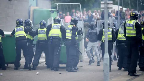 Riot police pictured at the scene of disorder on 4 August