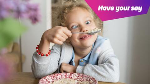 a girl enjoying a bowl of porridge