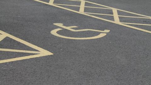 A disabled parking bay with the wheelchair logo.