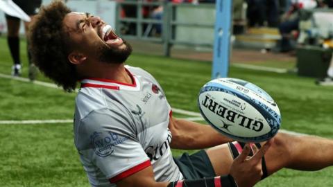 Andy Onyeama-Christie of Saracens celebrates after scoring his second try and Saracens fifth during the Gallagher Premiership Rugby match between Gloucester Rugby and Saracens at Kingsholm Stadium on September 21, 2024