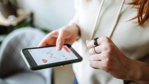 A person checks their fitness tracker data on their mobile phone.