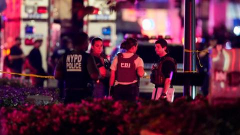 Police officers attend the scene of the shooting in New York