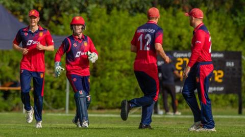 Jersey platers celebrate a wicket against Cyrprus