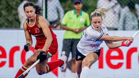 Ellie Mackenzie (right) prepares to take a shot as she is defended by Rachel Goodwin (left)