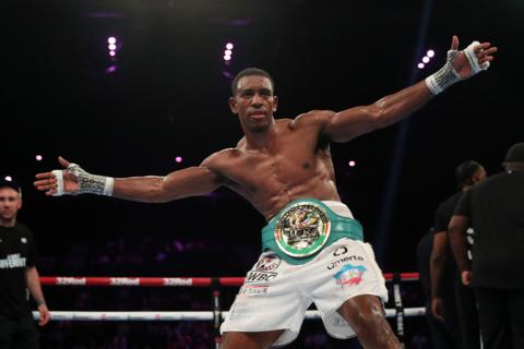 Ezra Taylor with his arms outstretched in the ring after claiming the WBC International light heavyweight title