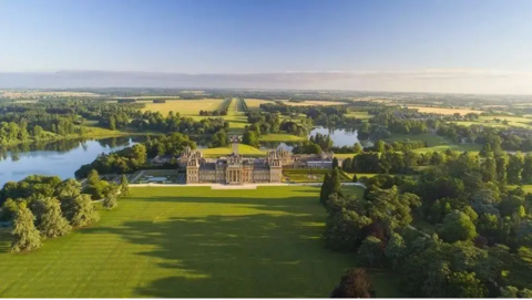 A bird's eye view of Blenheim Palace, with its sculptured gardens around it.