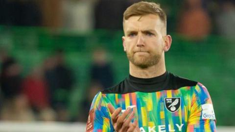 George Long applauds while playing for Norwich City