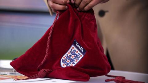 A red velvet bag containing the FA Cup draw balls