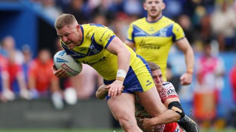 Warrington's Luke Yates shows his determination as he drives away from a tackle against Leigh Leopards last season
