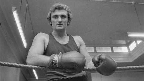 Joe Bugner posing in a gym in the 1970s