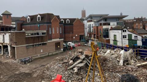 Demolition work at the former Riverside centre and medical practice, showing rubble and machinery