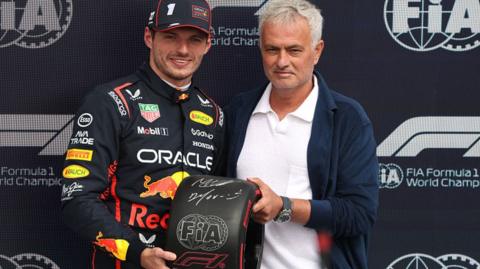 Max Verstappen poses for a picture as he receives the pole position trophy for the British Grand Prix from football manager Jose Mourinho