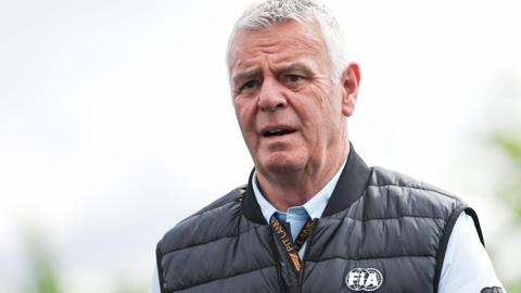 Derek Warwick looks on