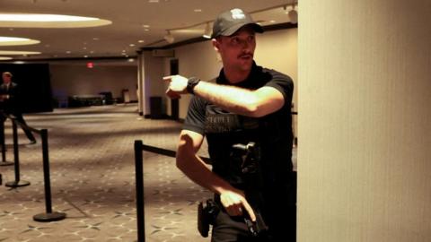  Secret Service agent gestures as a shooter opens fire during the annual White House Correspondents' Association dinner in Washington, D.C