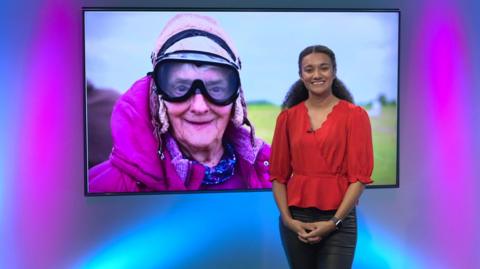 Nina in the studio with a granny in the screen