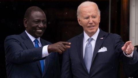 William Ruto and Joe Biden point to the crowd during an official White House event