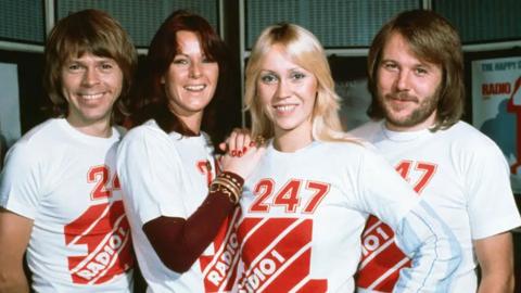 Abba wearing white and red t-shirts that read Radio 1 247.