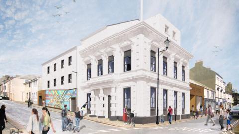 An artist's impression of the completed redevelopment of the former Carlton Cinema. It is an ornate three-storey building on a street corner, painted white with black window frames. A number of people are walking past.