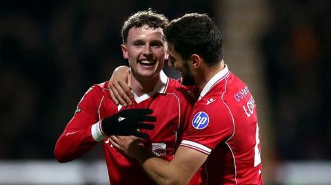Wrexham forward Nathan Broadhead (L) celebrates with Ryan Longman