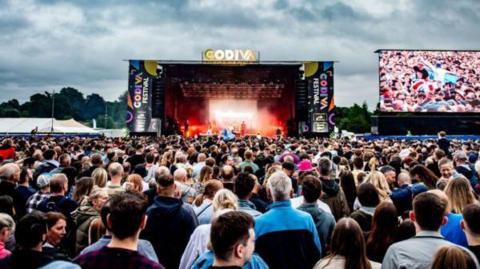 Picture of the main stage at Godiva festival where crowds of people gather.