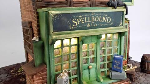 A tiny intricate shop front made from cake 